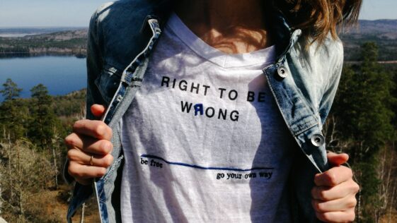 woman holding denim jacket