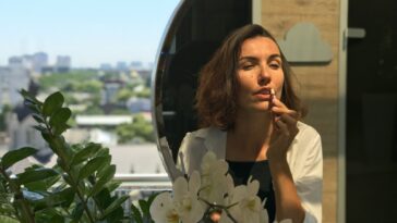 a woman holding a flower