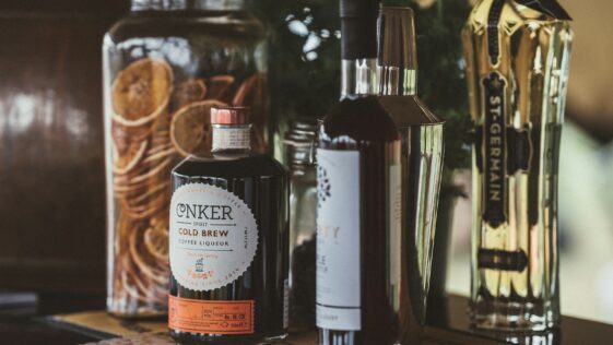 selective focus photo of two black and white labeled bottles