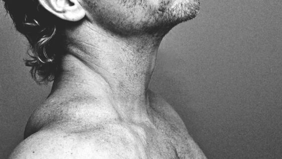 topless man with black and white hair
