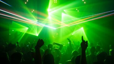 people dancing inside room with green lights