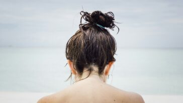 woman facing seashore