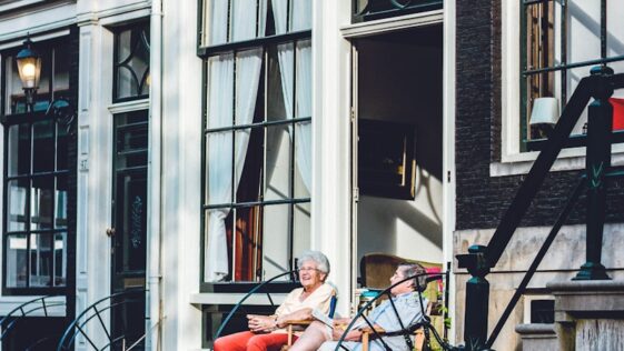 two person sitting in front of door
