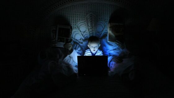 boy playing at laptop inside room